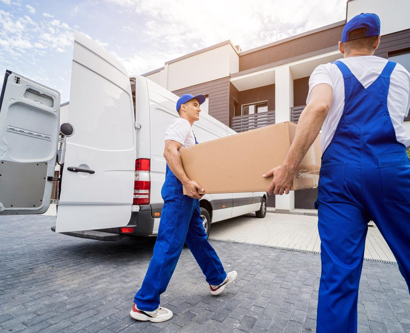 Residential movers unloading boxes from moving van – Moving Pro Dallas