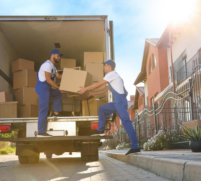 Long-distance movers unloading boxes from truck in residential area – Moving Pro Dallas