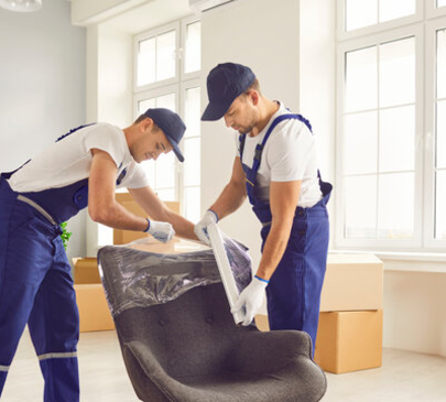 Movers protecting and wrapping armchair during home relocation – Moving Pro Dallas